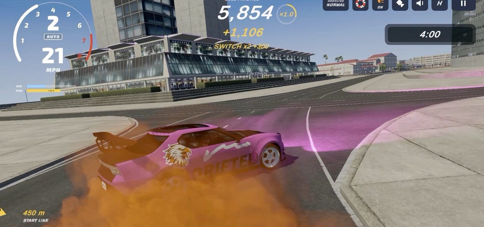 A pink car drifting in smoke in front of a glass-fronted grandstand