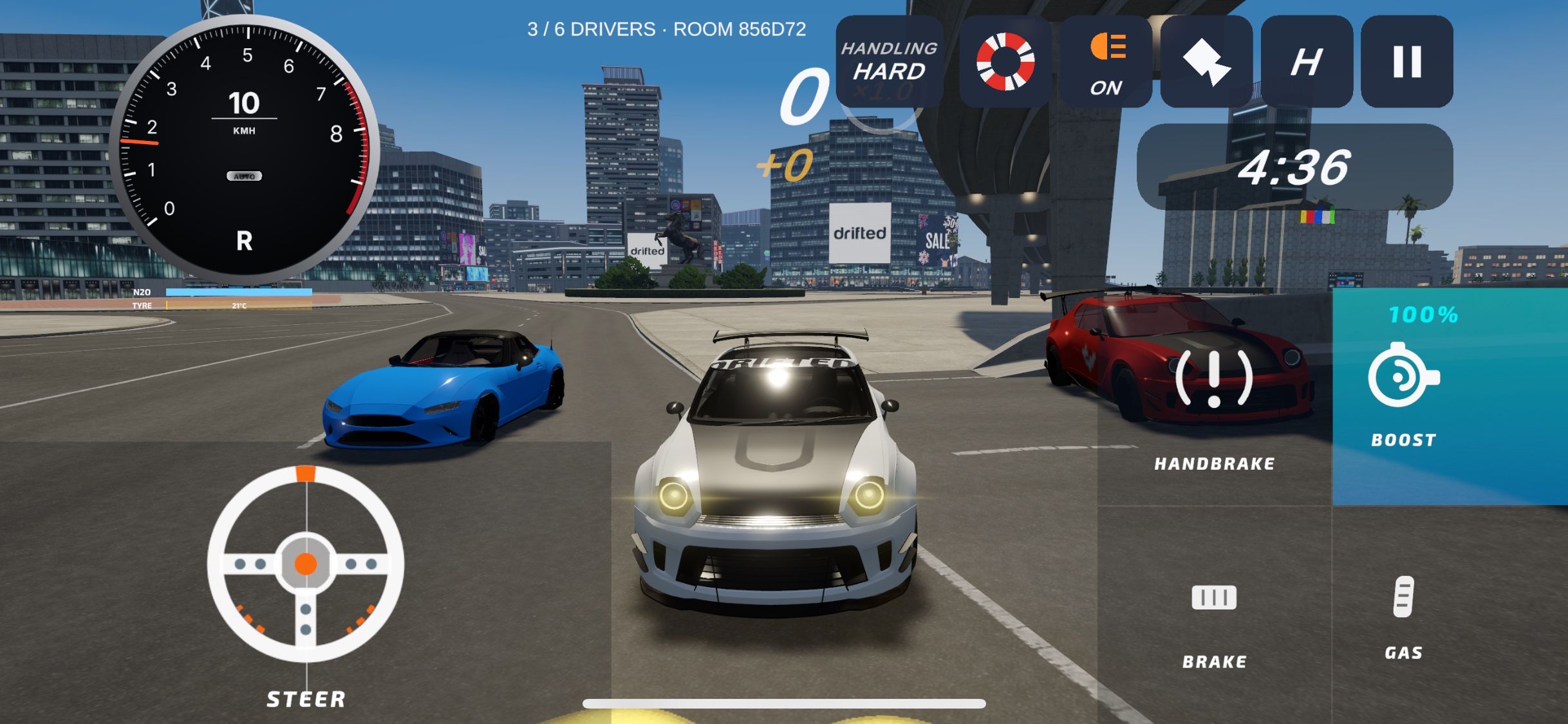 The same room from the front: a silver car with its headlights on between a blue car and a red car, city towers behind them